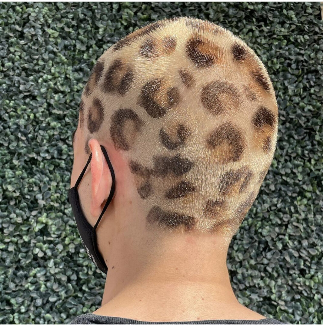 A man with leopard print hair on his head.
