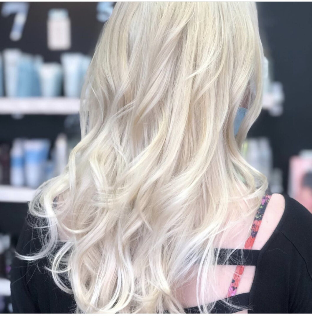 A woman with long blonde hair in a salon.