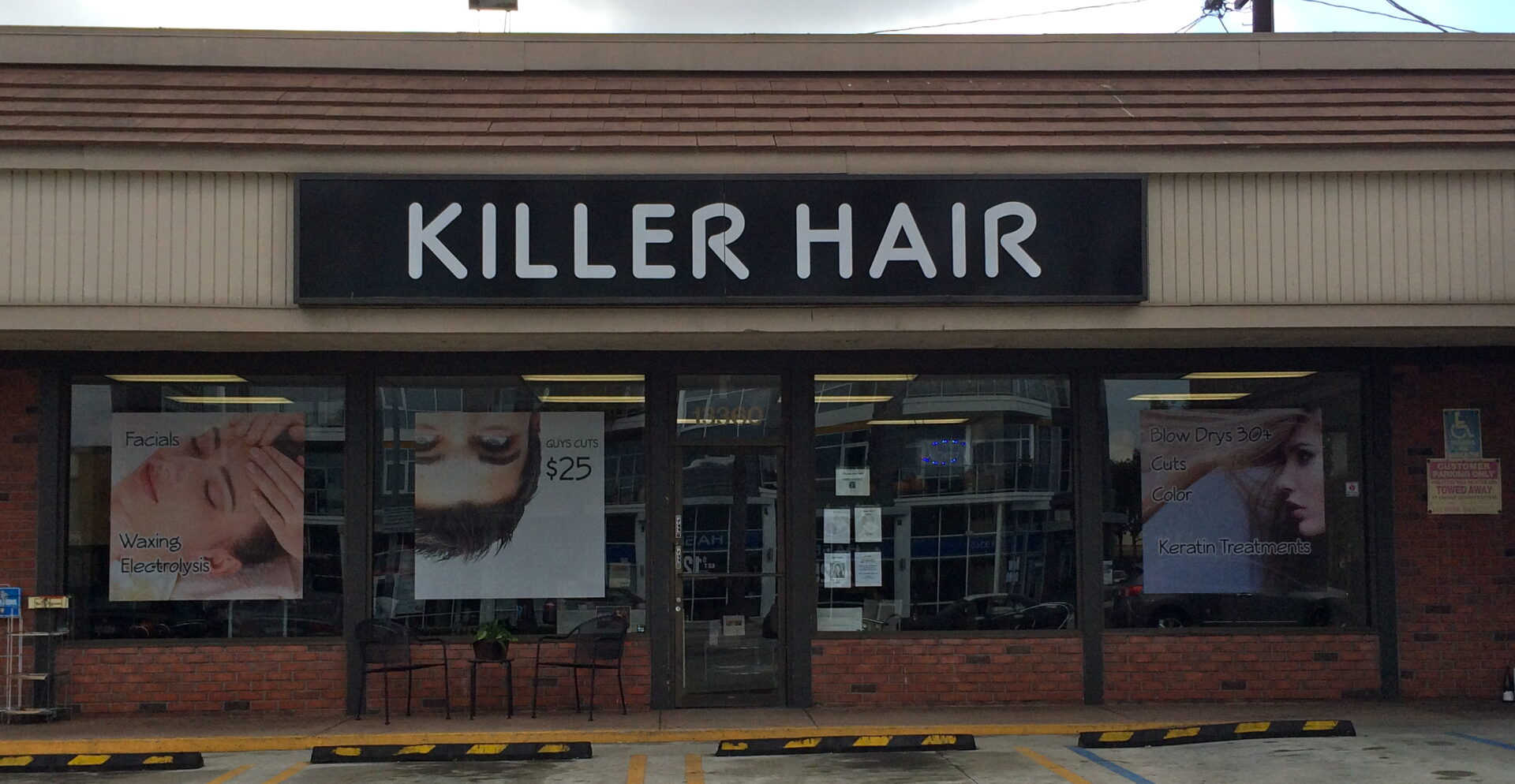 A store front with the words " killer hair ".