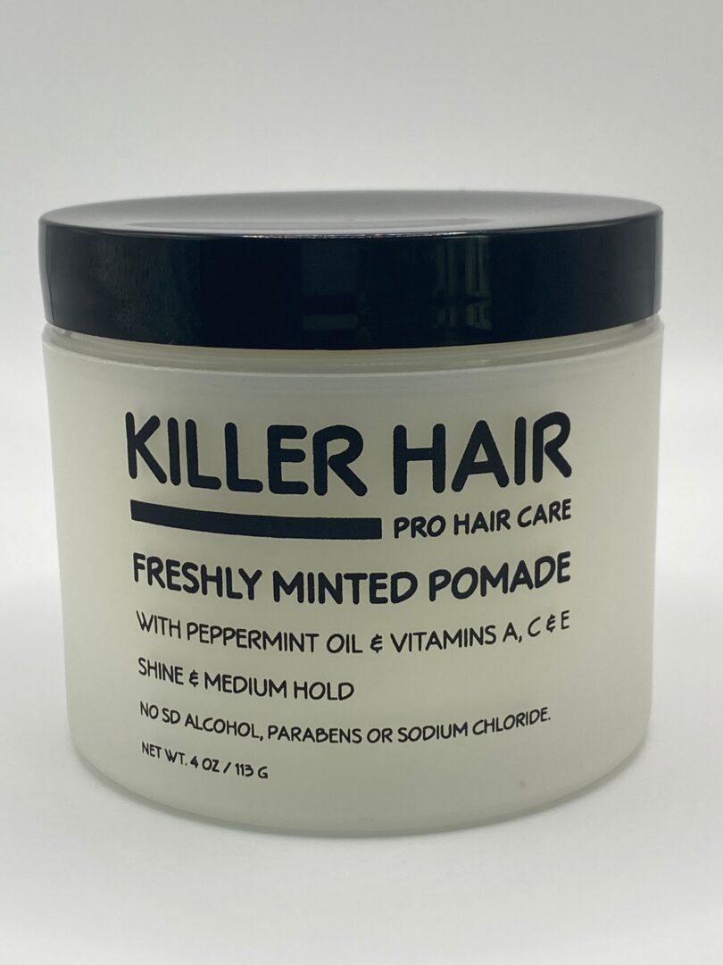 A jar of hair styling product with a white lid.